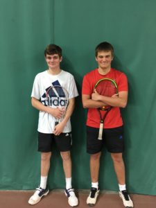 young tennis coaches posing with tennis rackets